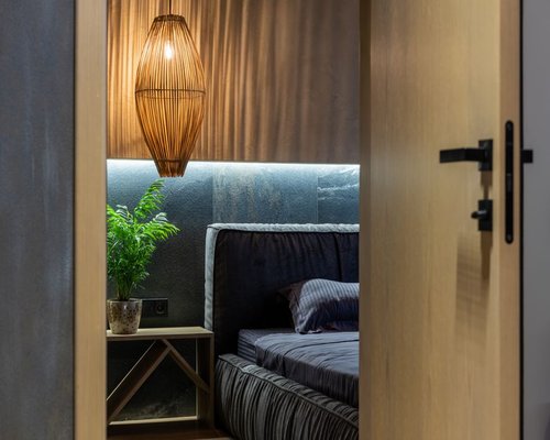 Minimalist adult bedroom featuring warm accent lighting creating a welcoming sleep environment